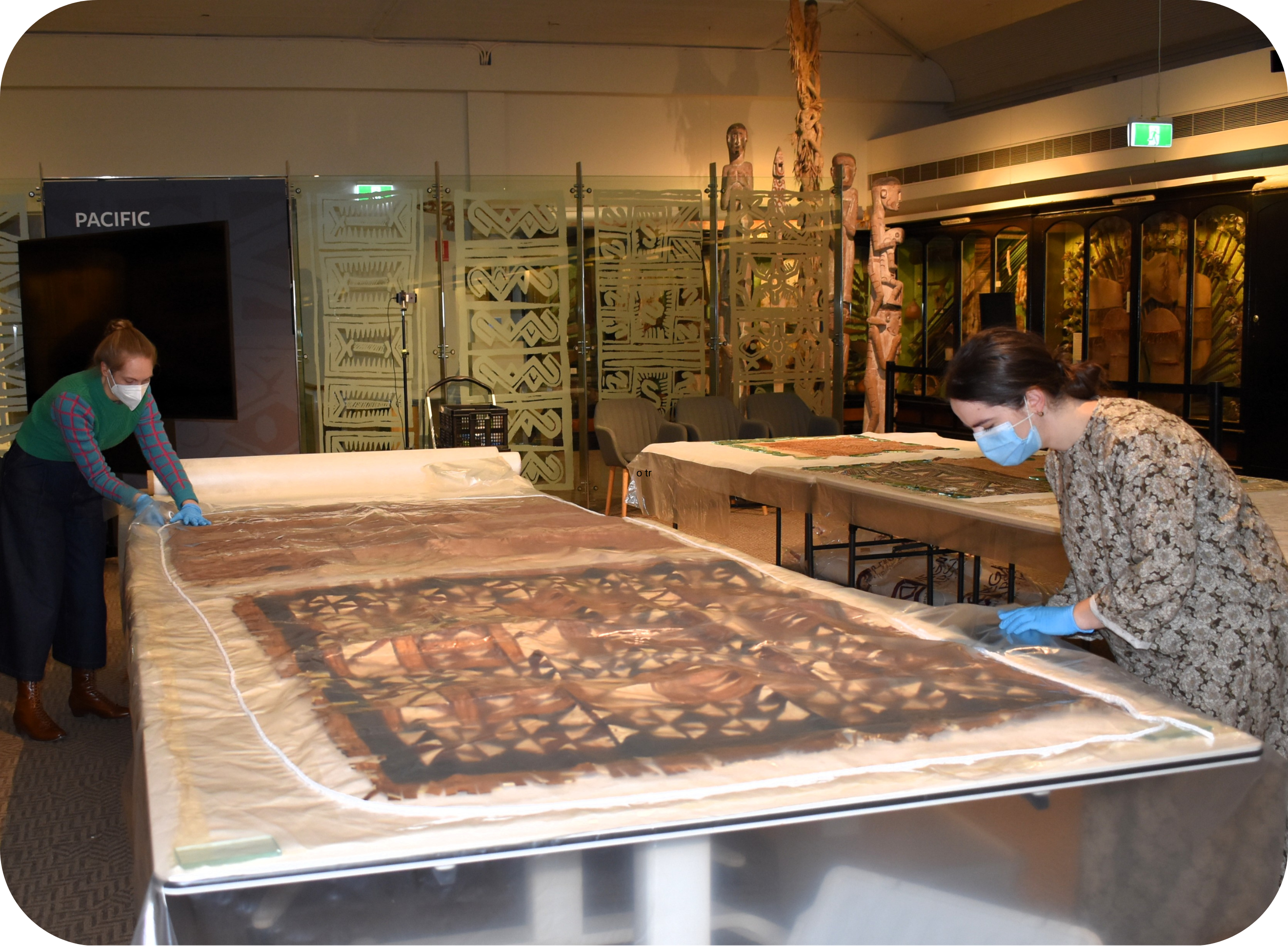 Artlab Australia&rsquo;s conservators at work on tapa in the Pacific Culture&rsquo;s Gallery