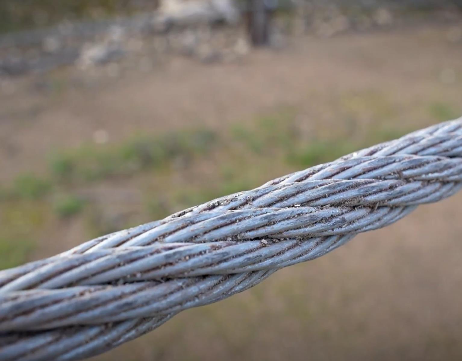 Close up of the cable, which is a woven metal cable about 22mm in width.