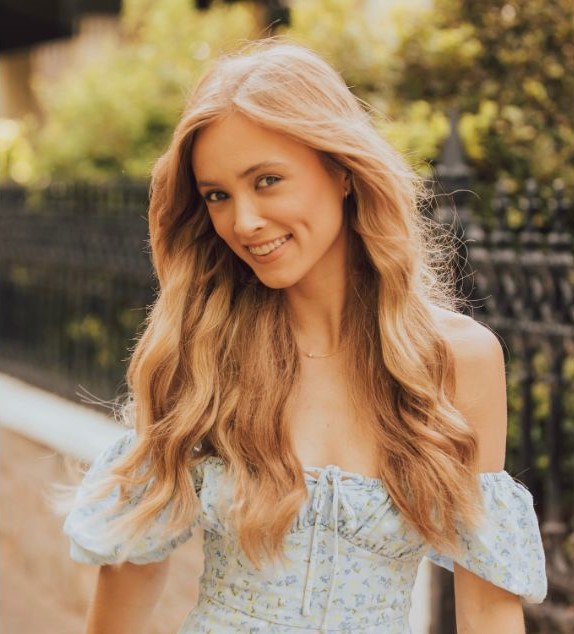 Image of Taydum, wearing a blue dress with long blonde hair.