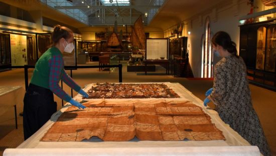 Artlab Australia’s conservators at work on tapa cloth in the Pacific Culture’s Gallery