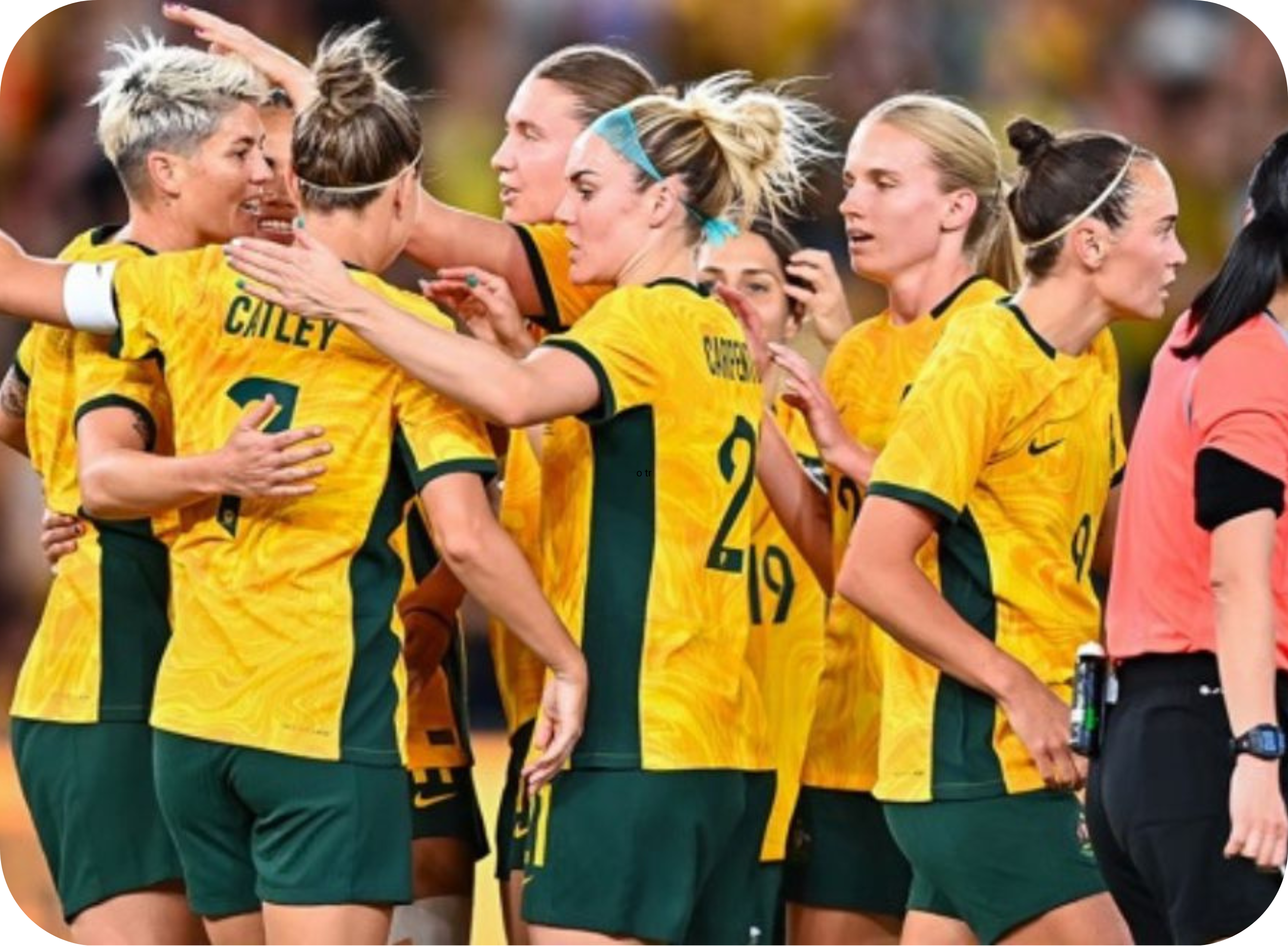 Matildas players gathered in a group celebrating