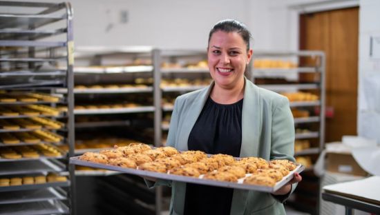 Image of Annunziata Thompson, holding a tray of cookies.