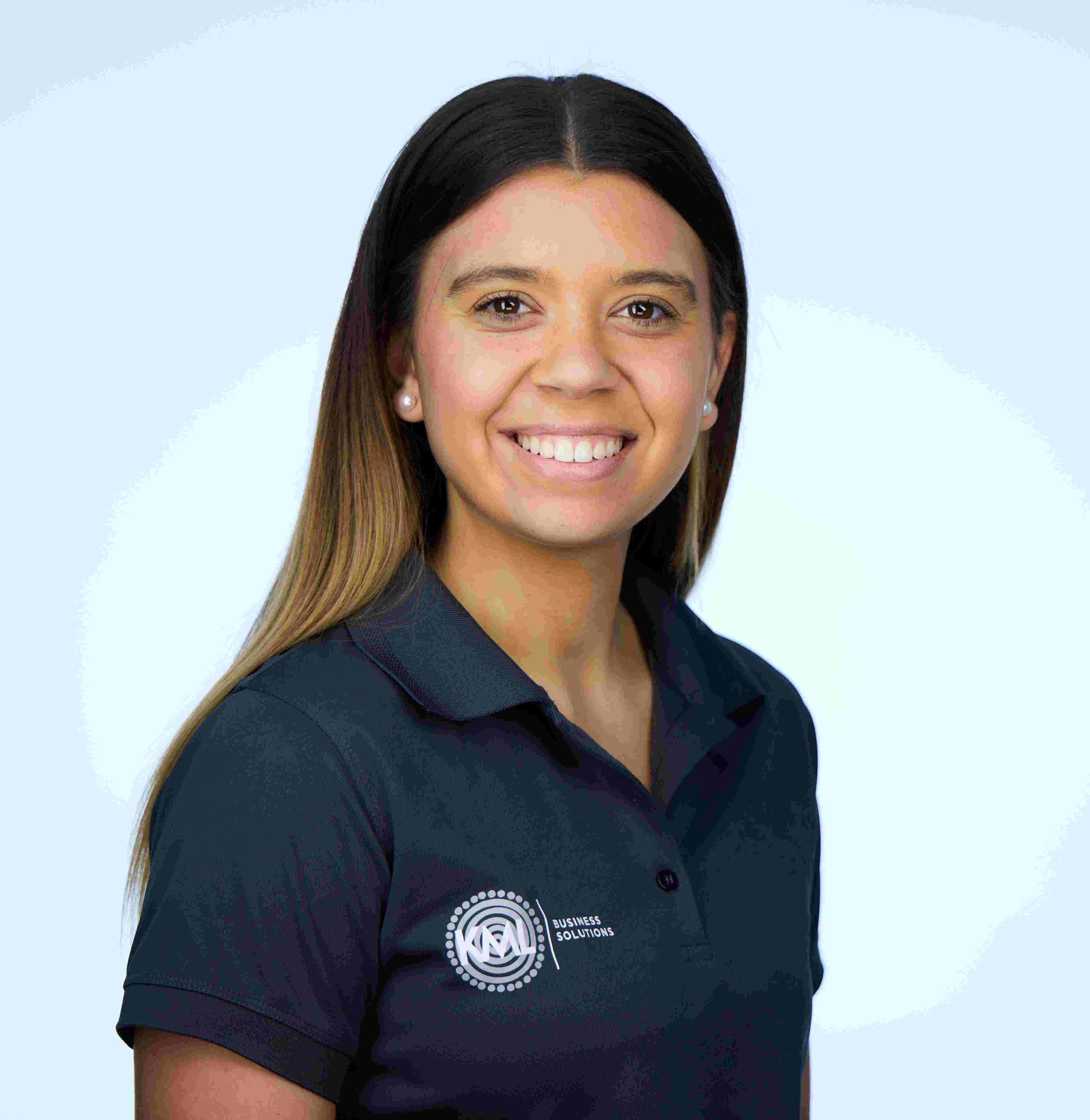 Image of Kedeisha, she is wearing a blue polo shirt and is in front of a light blue background.