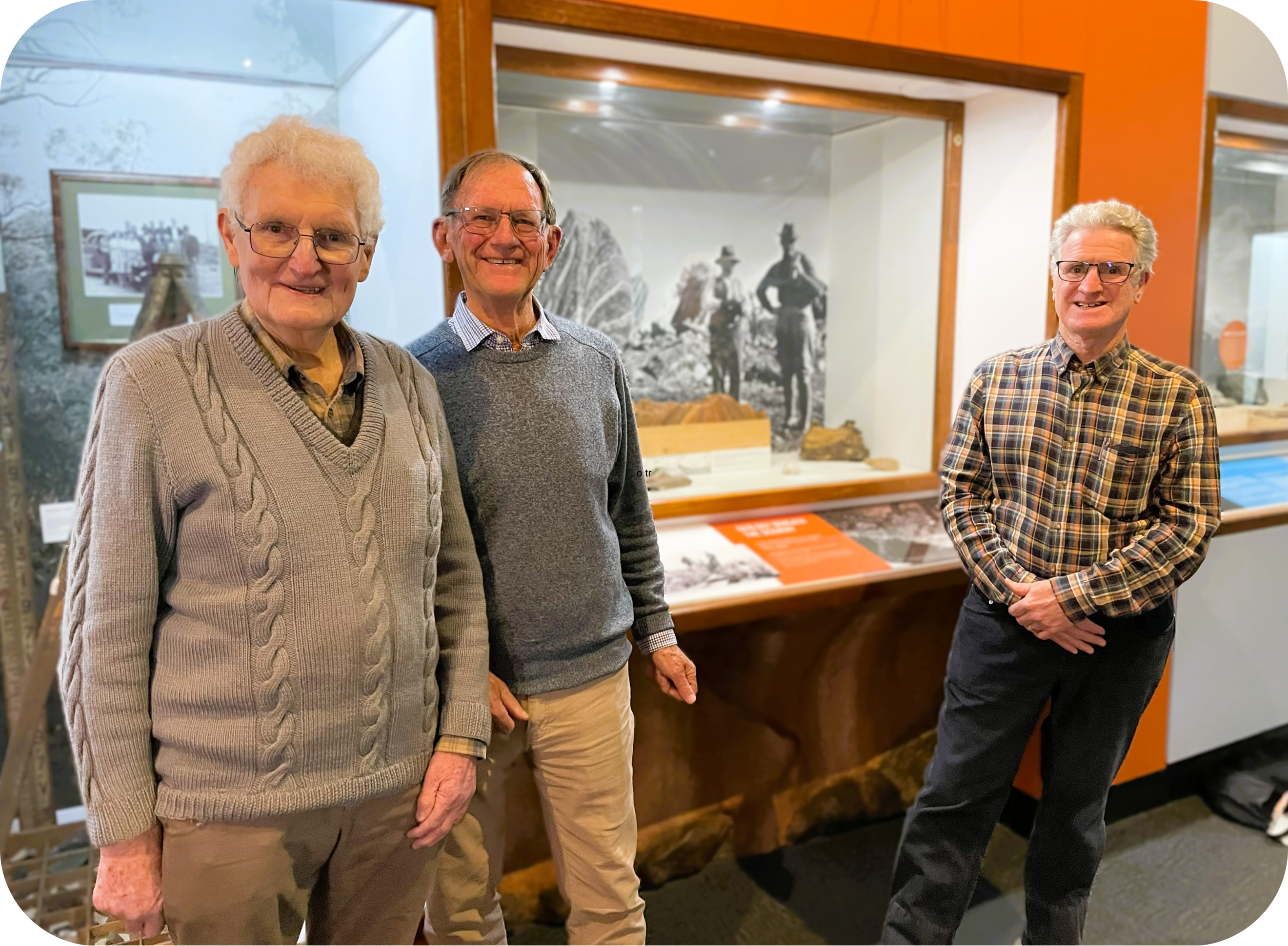 Photo of Jim Jago, Tim Tolley and Alun Thomas standing in front of a Sir Douglas Mawson display at the South Australian Museum.