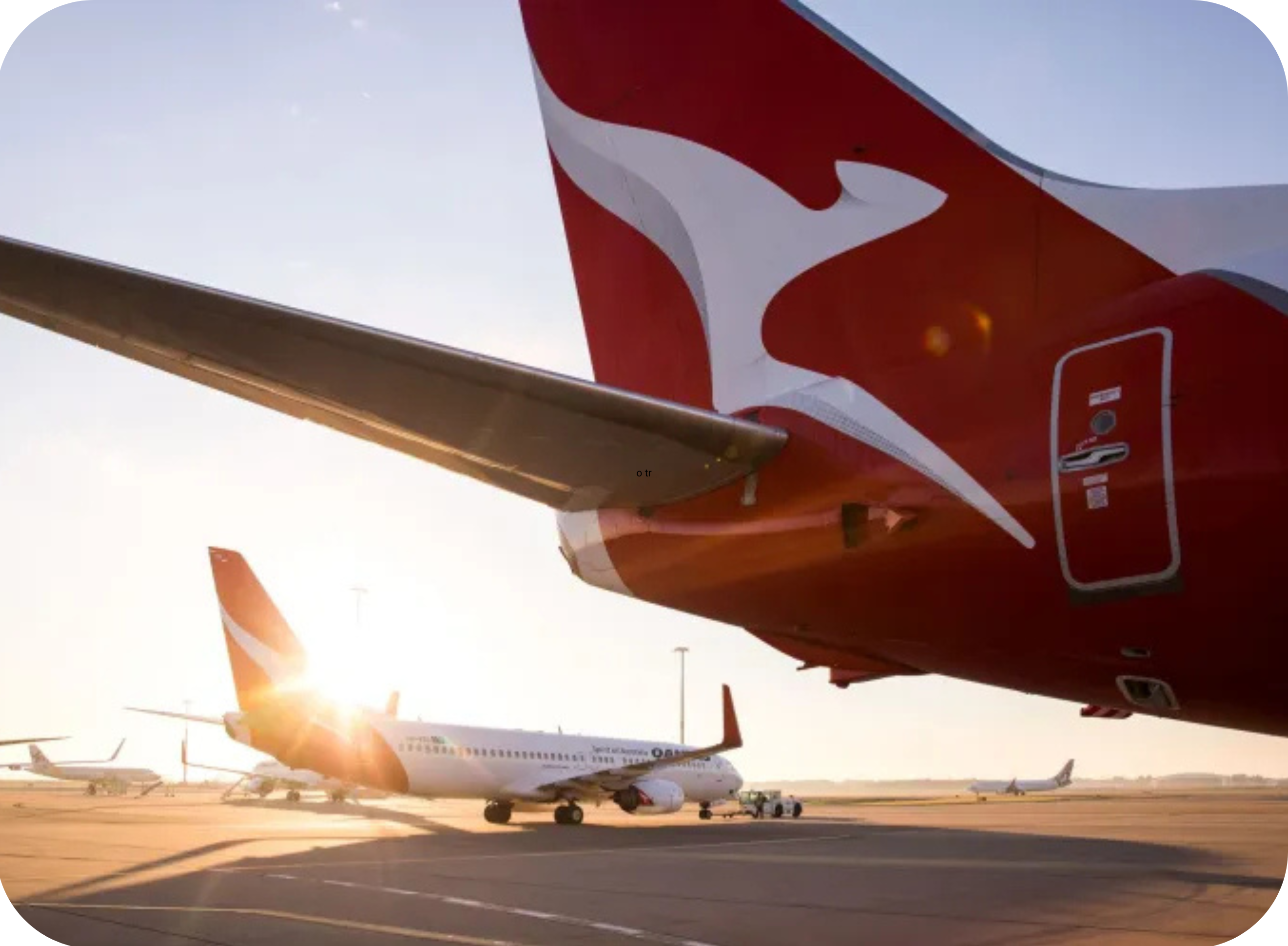 Two Qantas planes pictured on airport tarmac