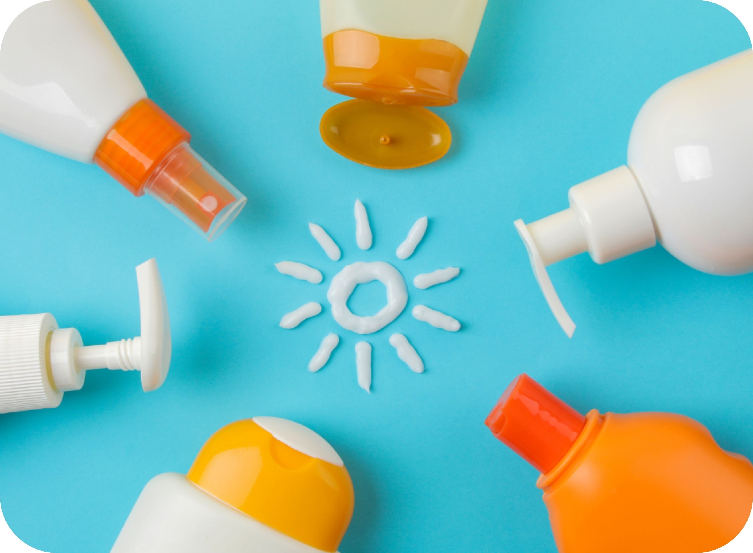 Six sunscreen bottles laying in a circle on a blue background with a sun drawn in sunscreen in the middle