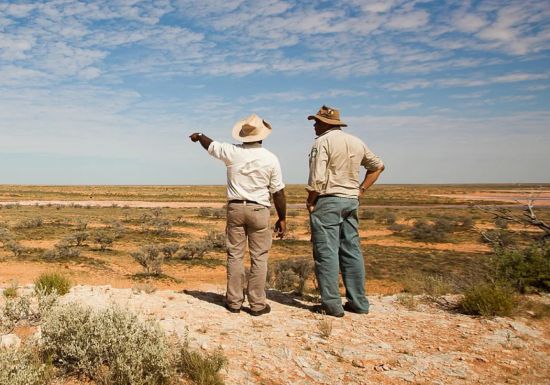 Image of two Aboriginal rangers overlooking national park