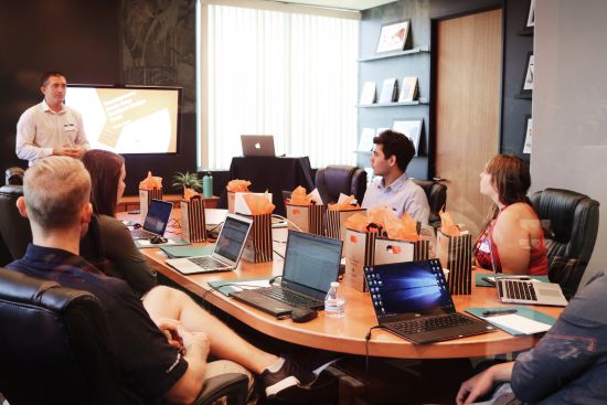 Image of a a group of people sitting around a table.