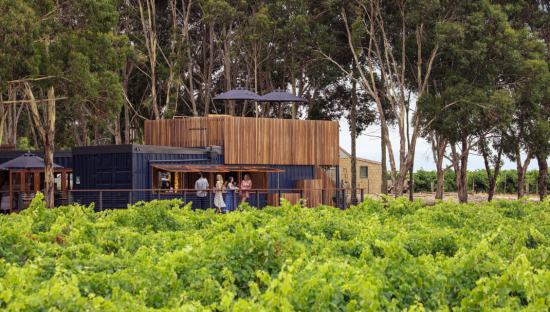 Image of people enjoying drinks on a deck at Kimbolton Wines.