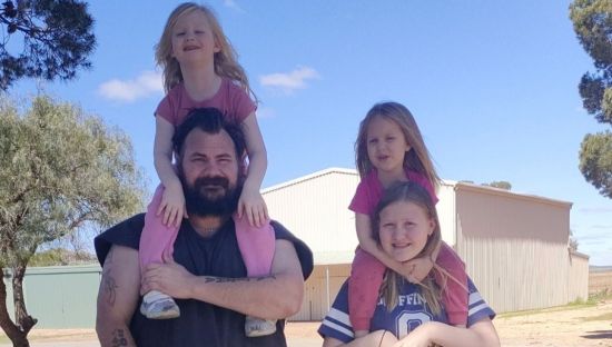 Image of a man with three of his daughters.