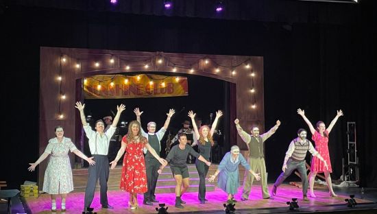 Image of people performing on stage at the Sunshine Club performance.