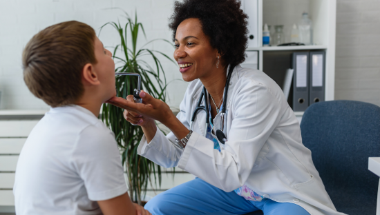 Image of a child being examined by a doctor for a sore throat
