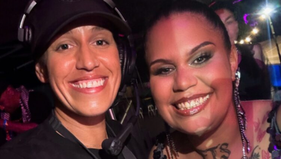 Image of two individuals smiling 