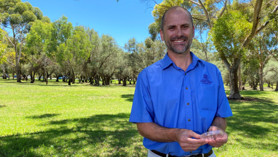 Image of Department of Primary Industries and Regions (PIRSA) Plant and Invasive Species Biosecurity Director, Nick Secomb with a peri-dish of the sterile fruit flies.