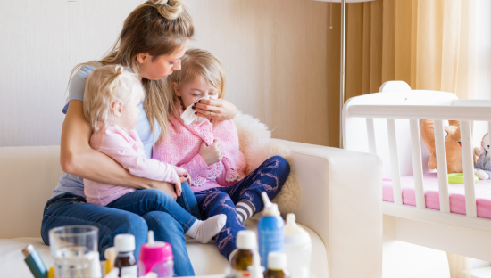 Image of two sick children with the flu being cared for by their mother