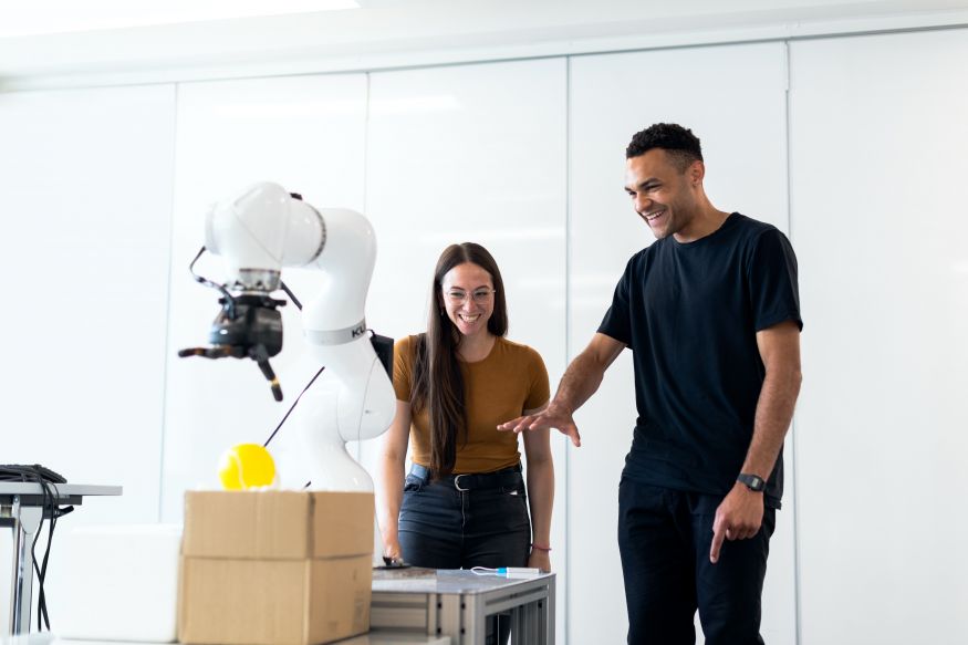 Image of two people working with a innovative robotic solution