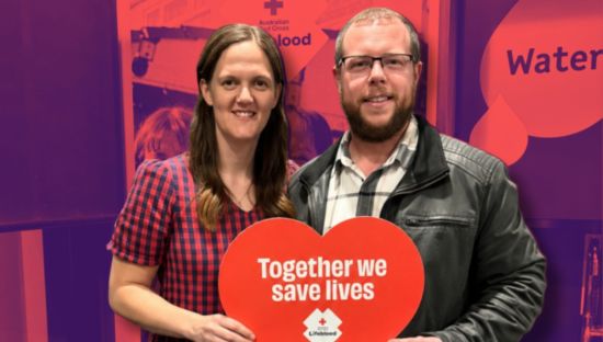 Couple Alissa and Doug holding up a sign that says 'Together we save lives'